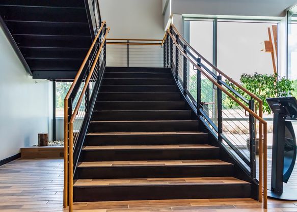Monumental steel staircase with stained would treads