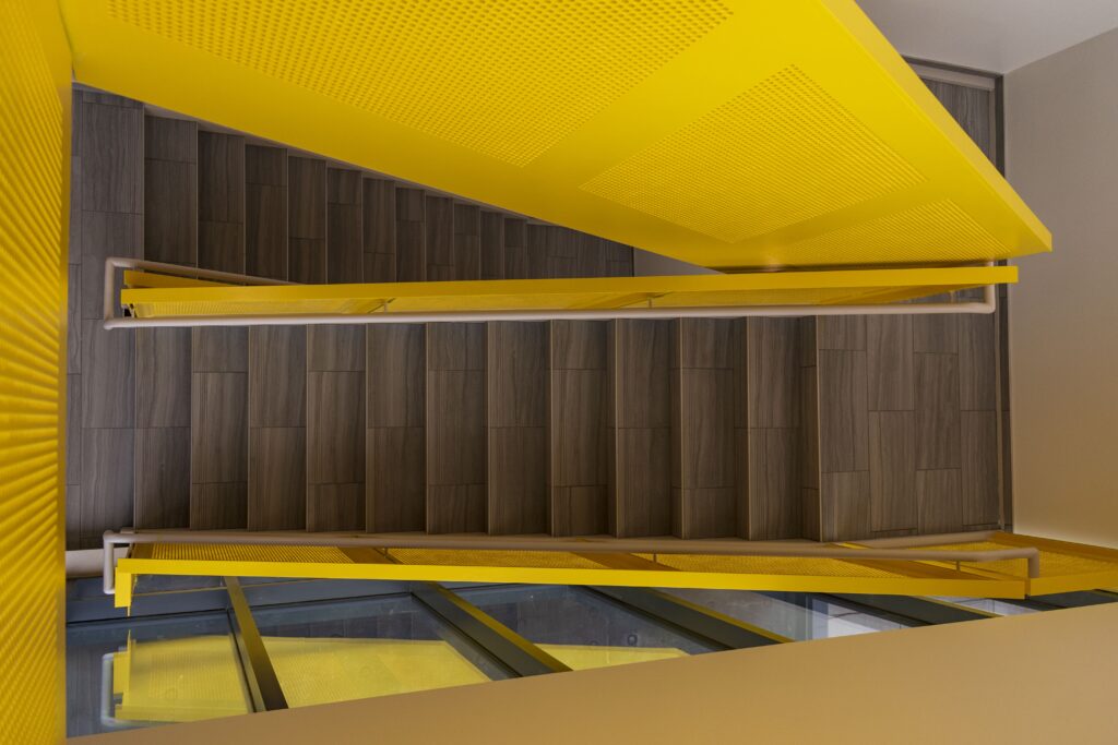 Overhead view of steel and oak staircase with yellow screen side rails