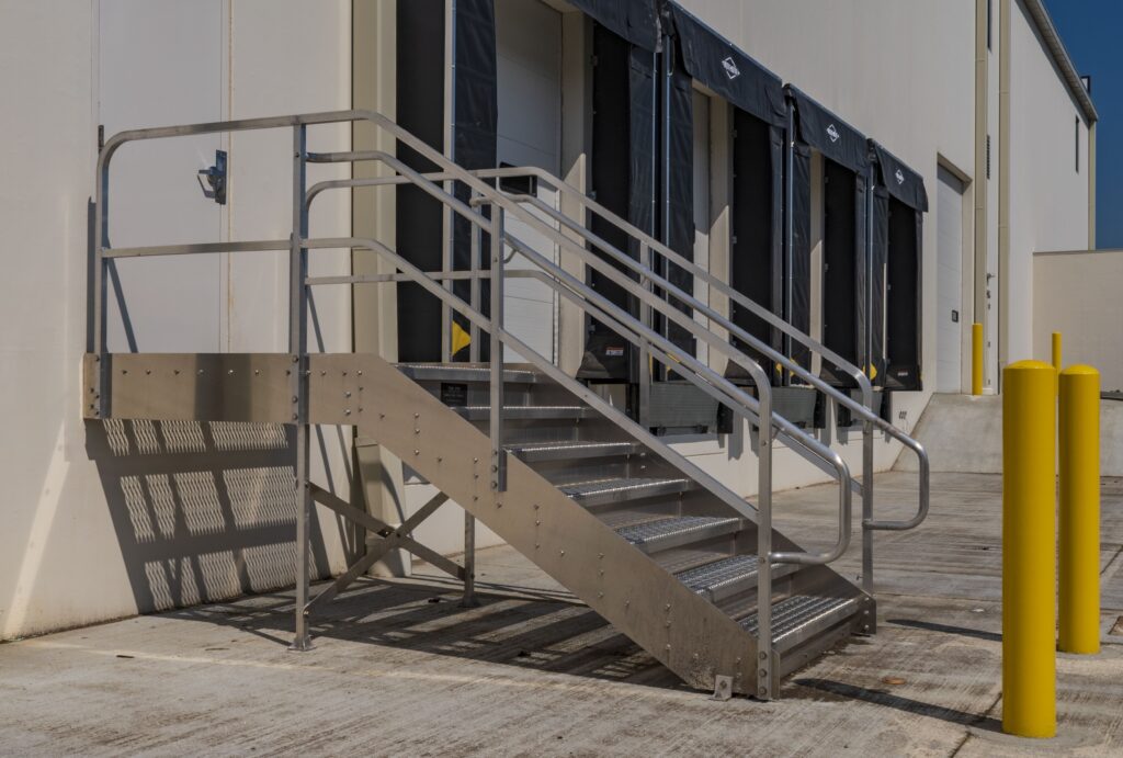 Wide left view of Aluminum dockstair and bollards installed at exterior man-door