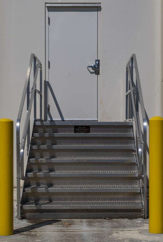 Front view of Aluminum dockstair and bollards installed at exterior man-door