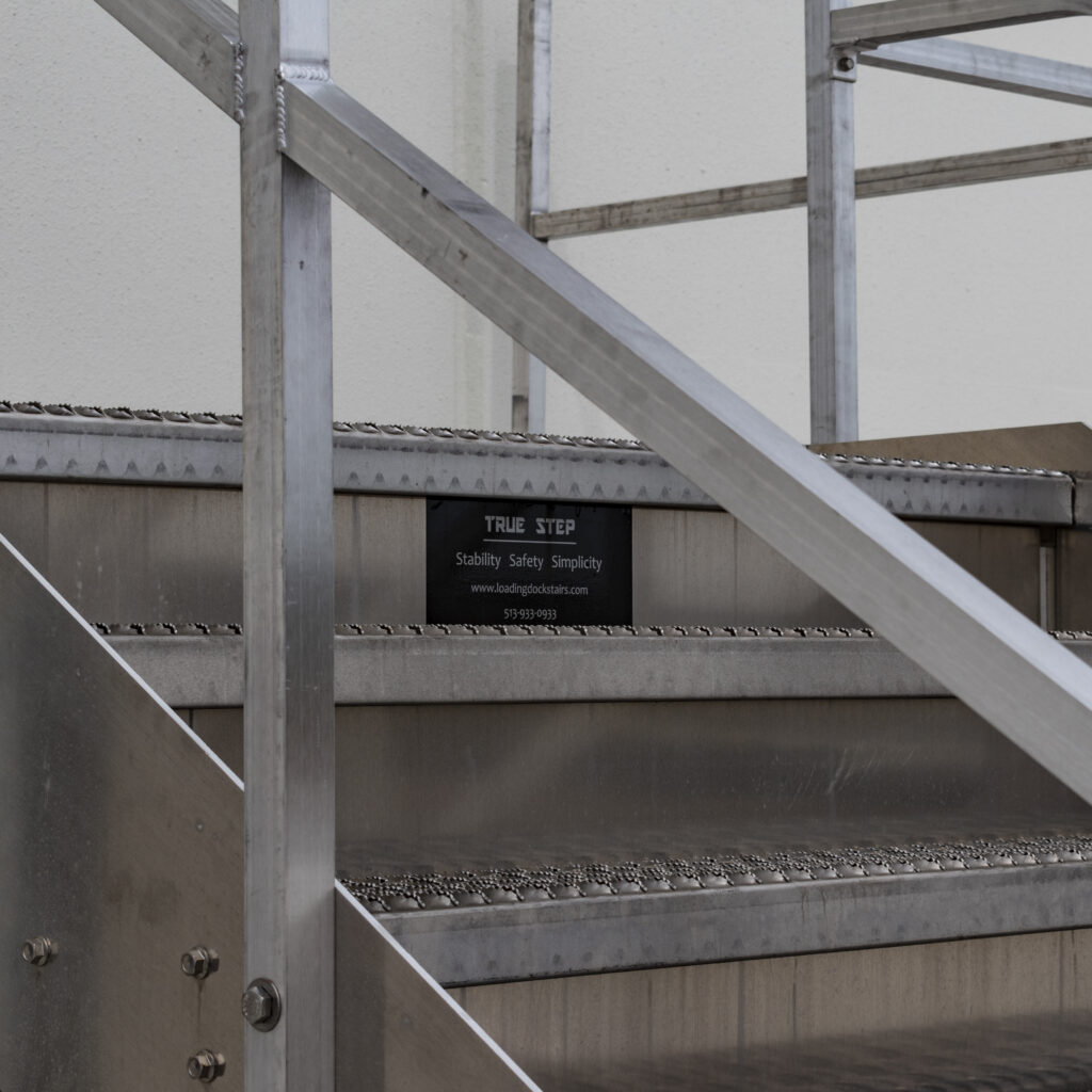 Left tight view of aluminum dock stair and True Step placard