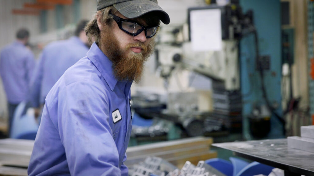 Worker handling aluminum railing components