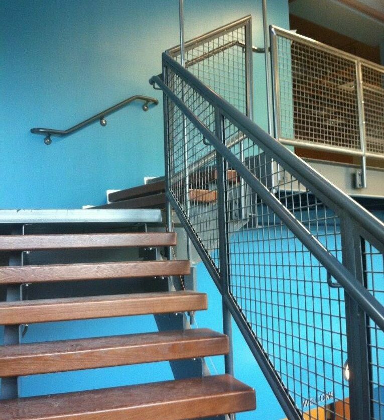 Gray steel, oak, and mesh staircase