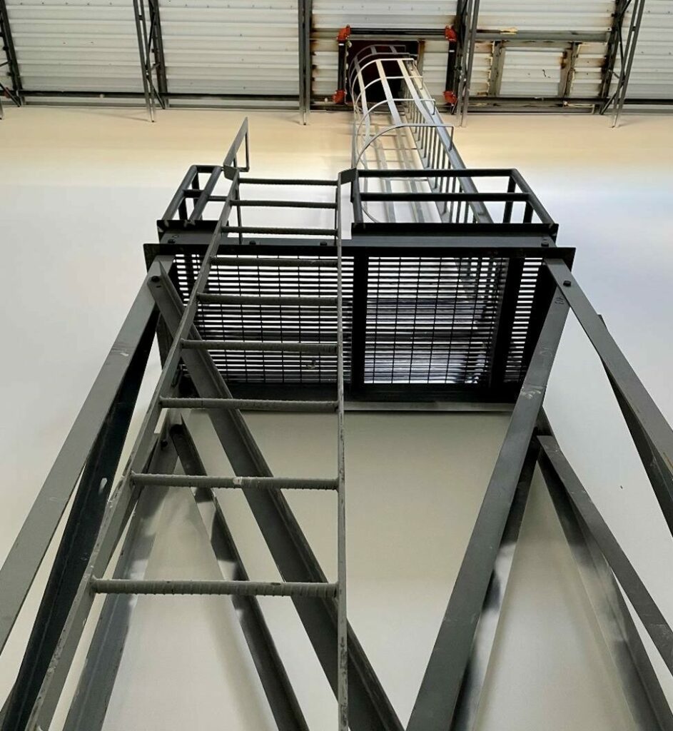 Steel cage ladder with platform