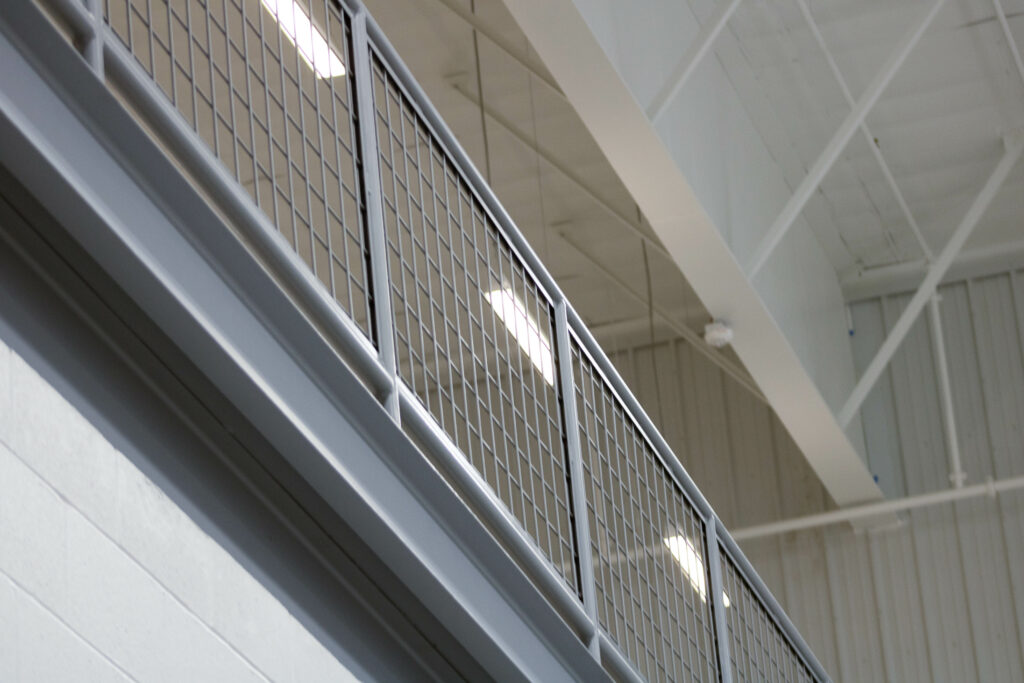 Painted gray steel mesh railing on mezzanine