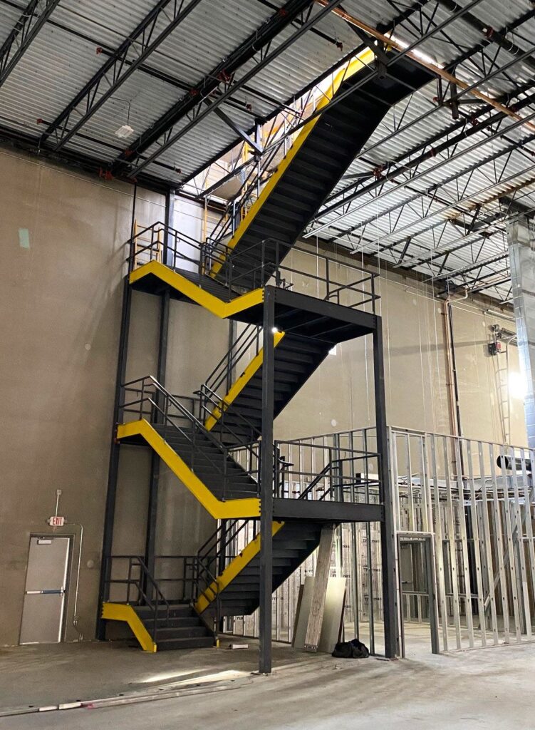 Full size roof access stairs inside warehouse