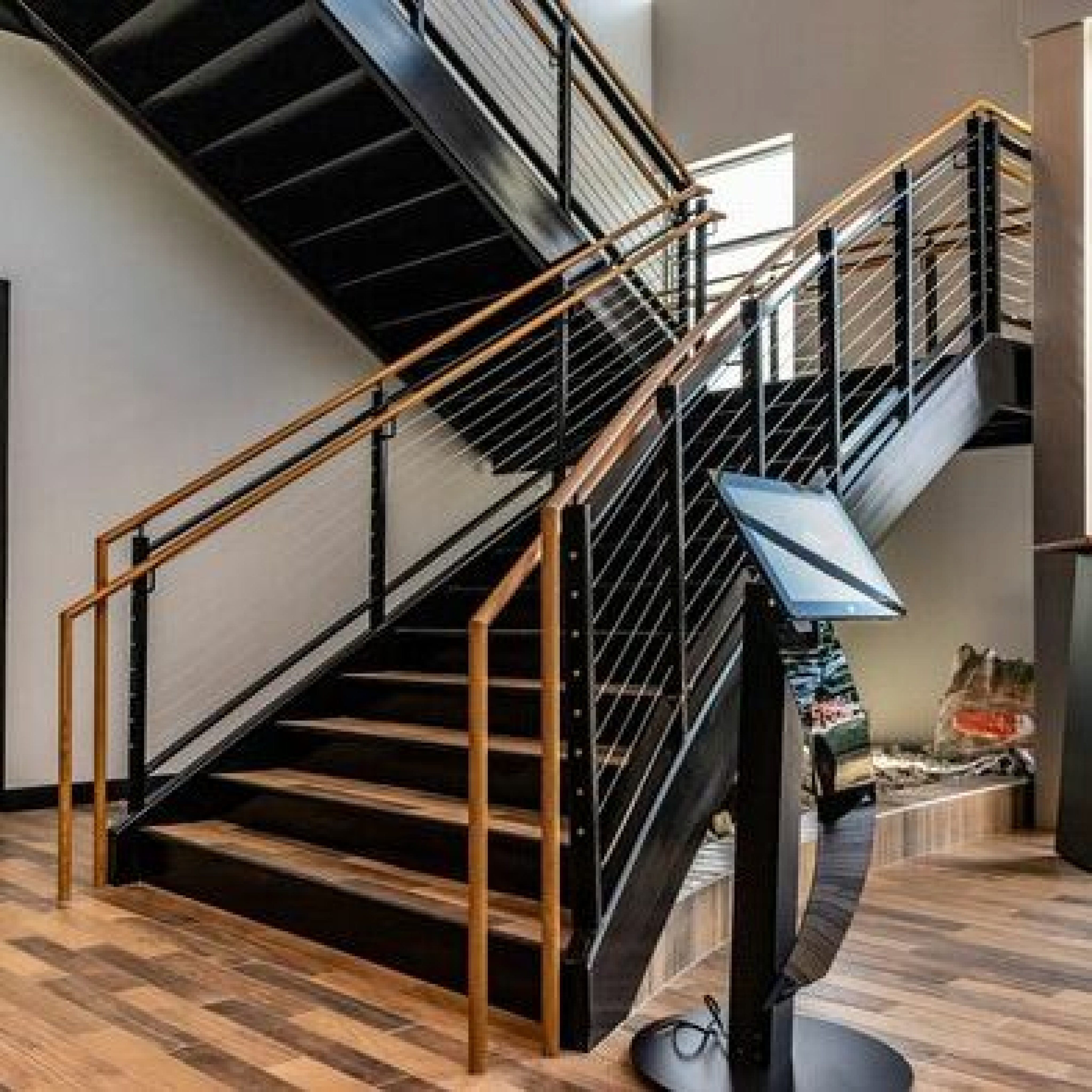 Side-view of monumental steel staircase with stained wood treads